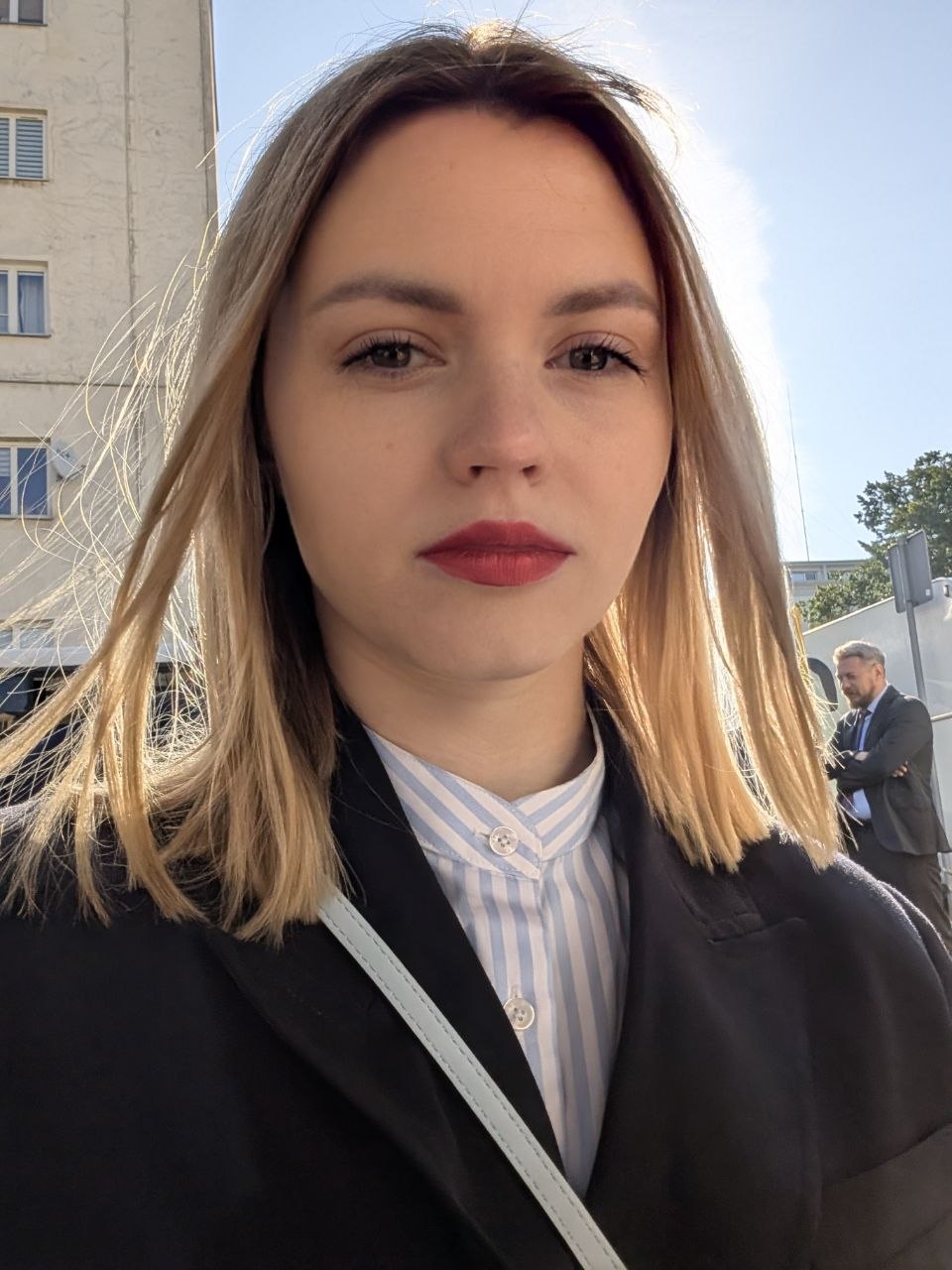 Outdoor headshot — red lip, tailored blazer