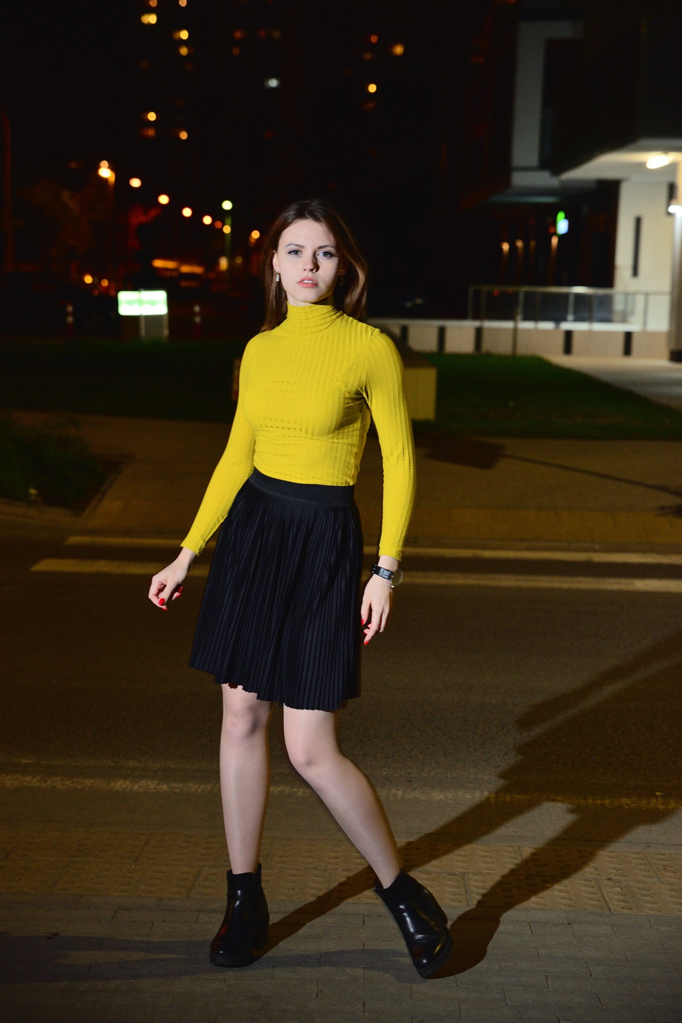 Evening street portrait — yellow knit and pleated skirt