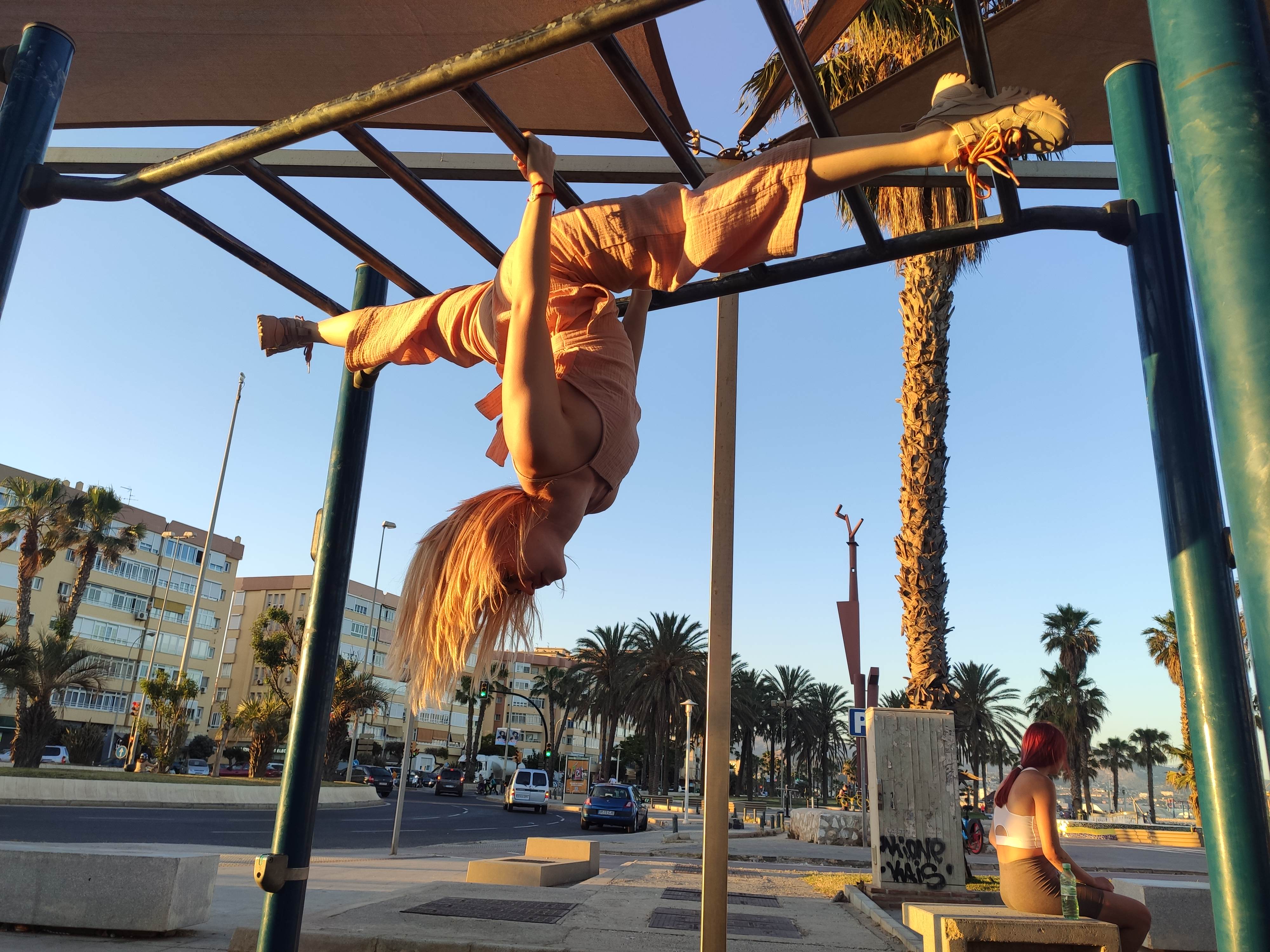 Aerial pose on seafront bars at golden hour