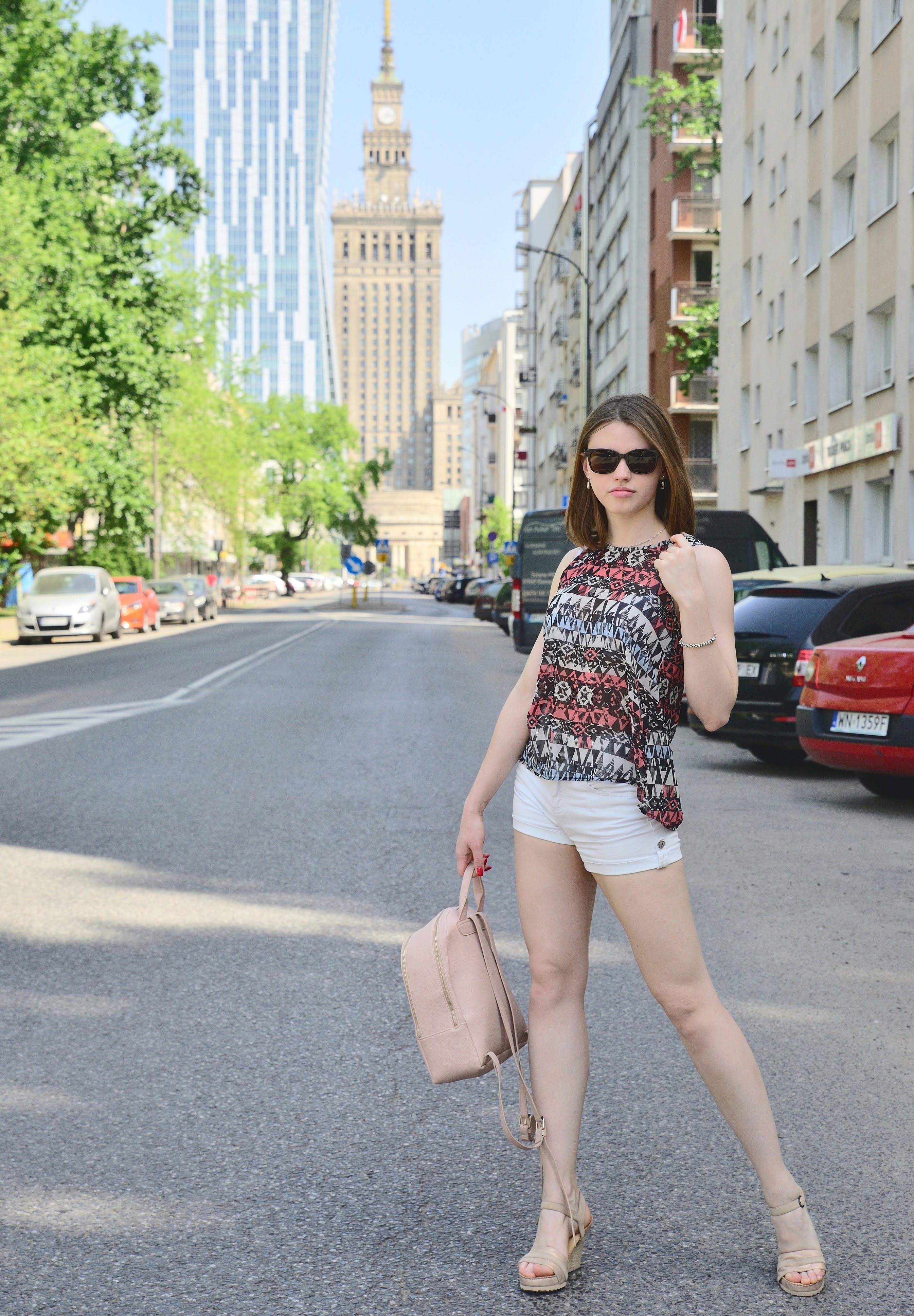 Street editorial in central Warsaw — patterned top and white shorts